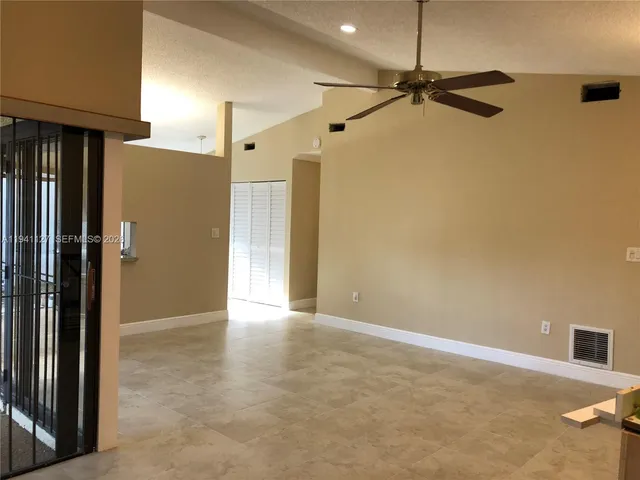 a view of a big room with closet and windows