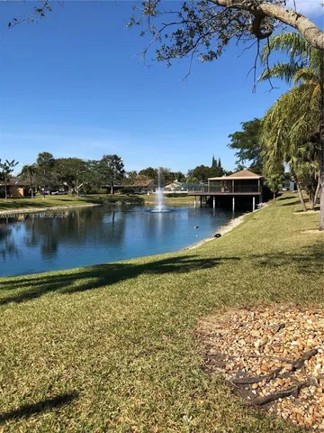 a view of a lake with houses in the background