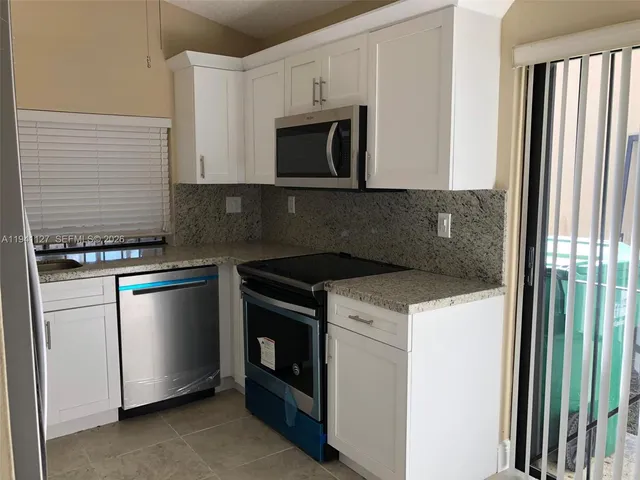 a kitchen with a stove and a microwave