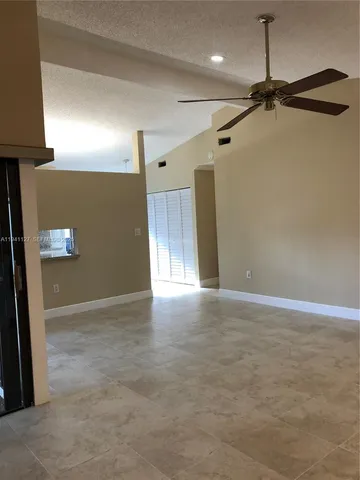 a view of a livingroom with a ceiling fan and window