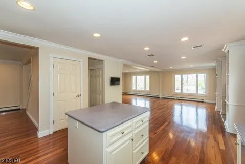 a view of a kitchen cabinets a wooden floor and a window