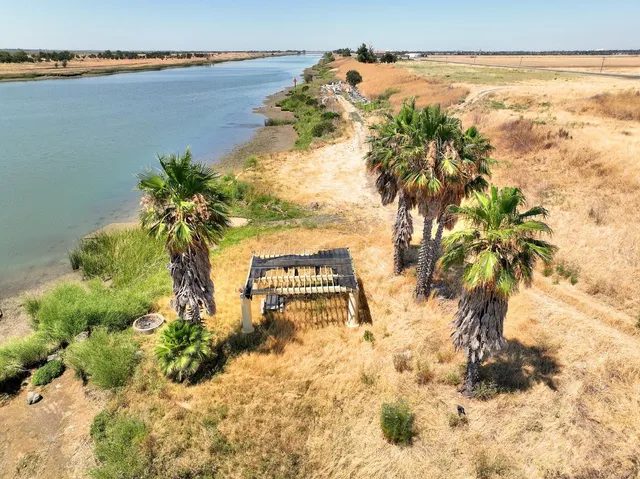 a view of a yard with wooden fence