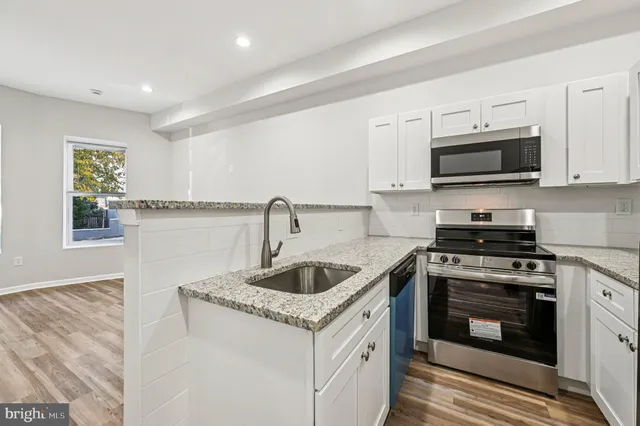 a kitchen with a sink and cabinets