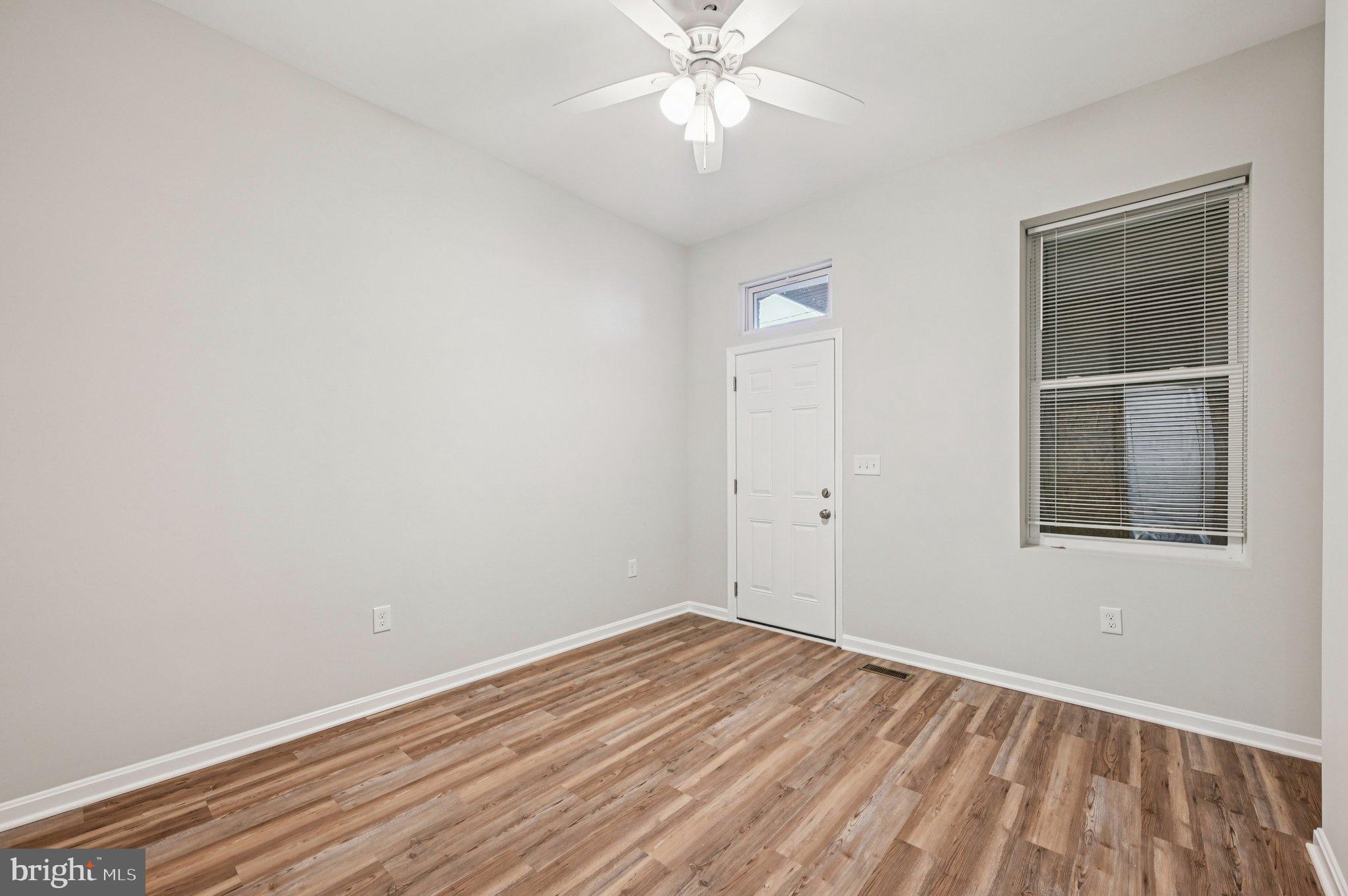 750 Reservoir Street, Unit A Baltimore, MD 21217 - Photo 20 of 23 wooden floor in an empty room with a window
