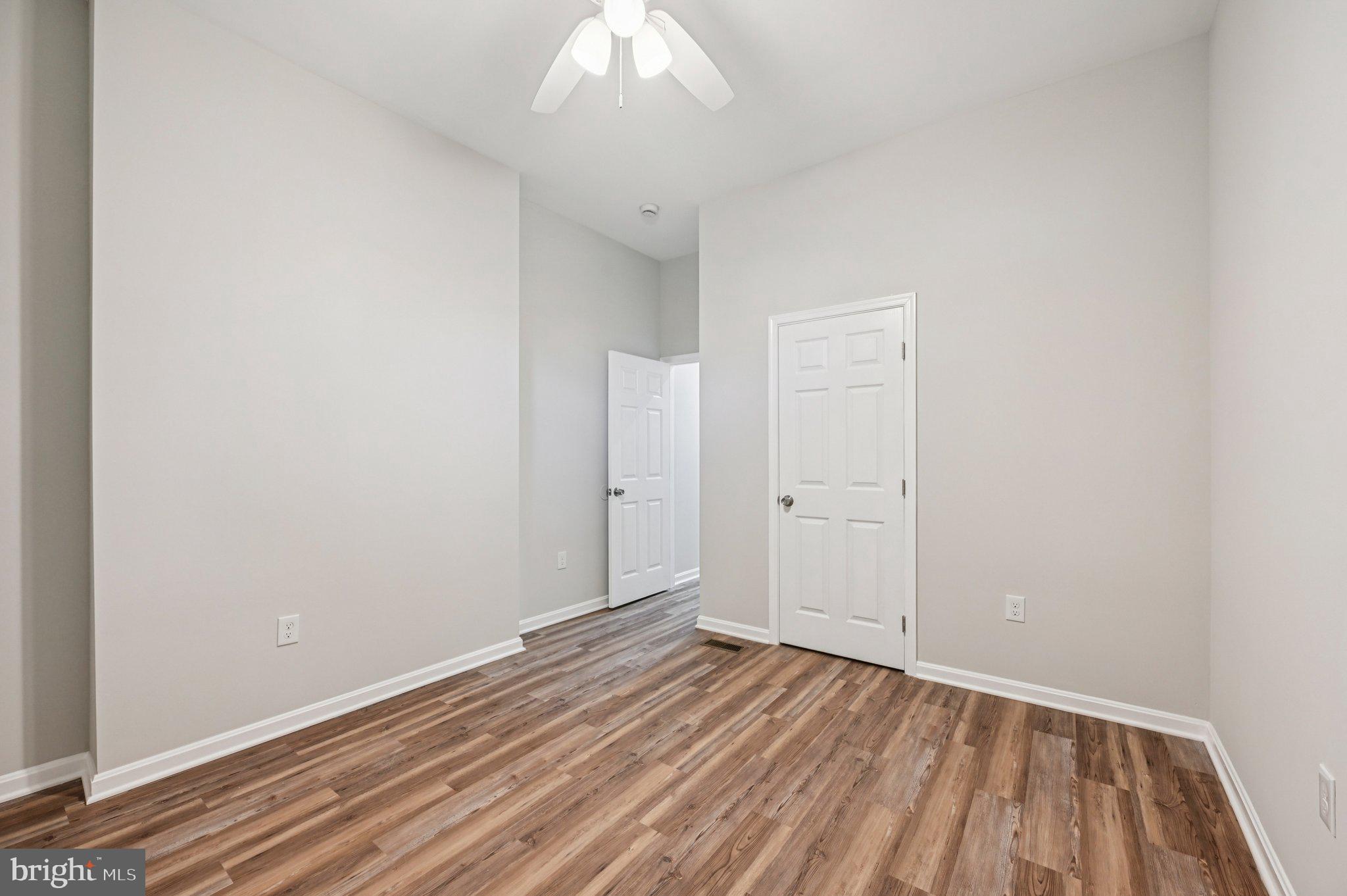 750 Reservoir Street, Unit A Baltimore, MD 21217 - Photo 22 of 23 an empty room with wooden floor and windows
