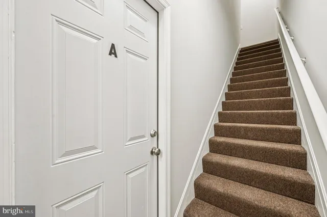 a view of staircase with white walls