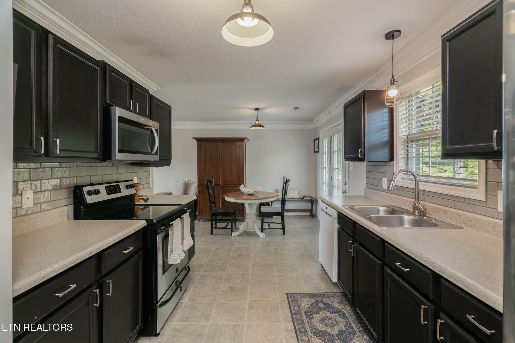 8431 Vessel Lane Powell, TN 37849 - Photo 20 of 46 a kitchen with stainless steel appliances a sink stove and microwave