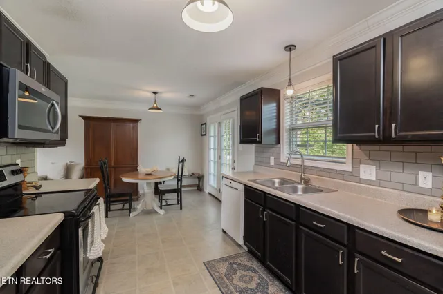 a kitchen with lots of counter space a sink and a refrigerator