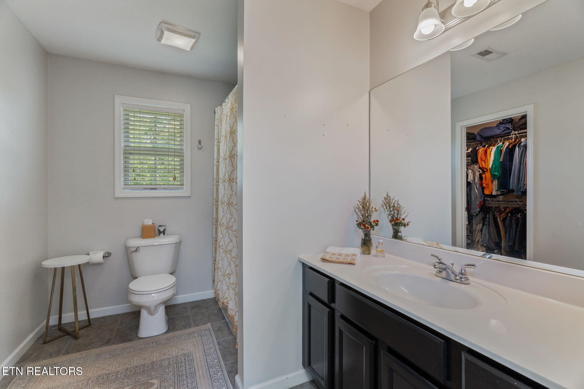 8431 Vessel Lane Powell, TN 37849 - Photo 27 of 46 a bathroom with a sink a toilet and a large mirror