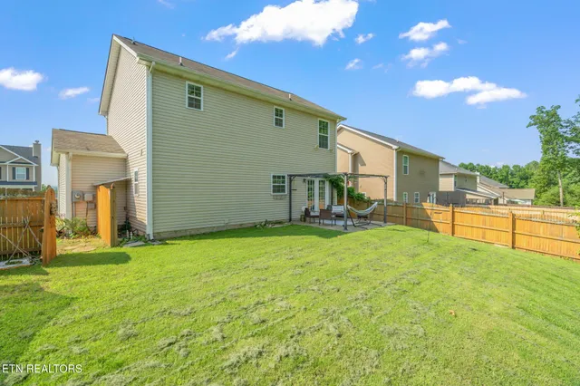 a backyard of a house with table and chairs