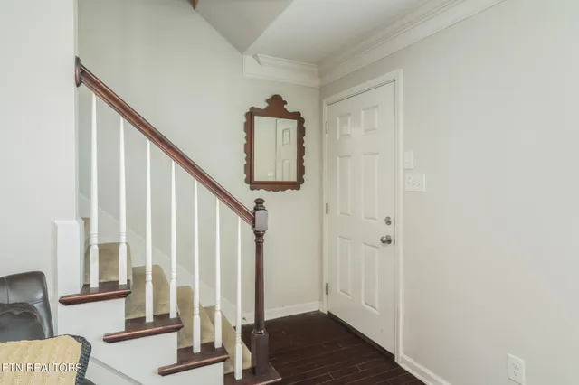 a view of an entryway with wooden floor and door