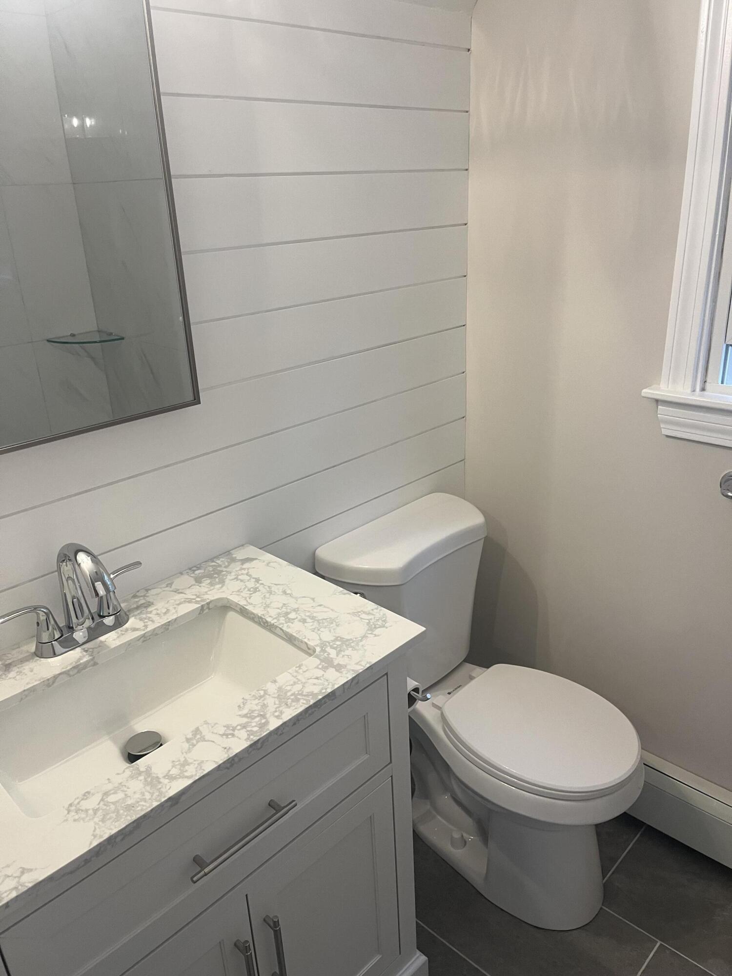 49 Burnham Street Barnstable, MA 02648 - Photo 11 of 17 a white toilet sitting next to a bathroom sink