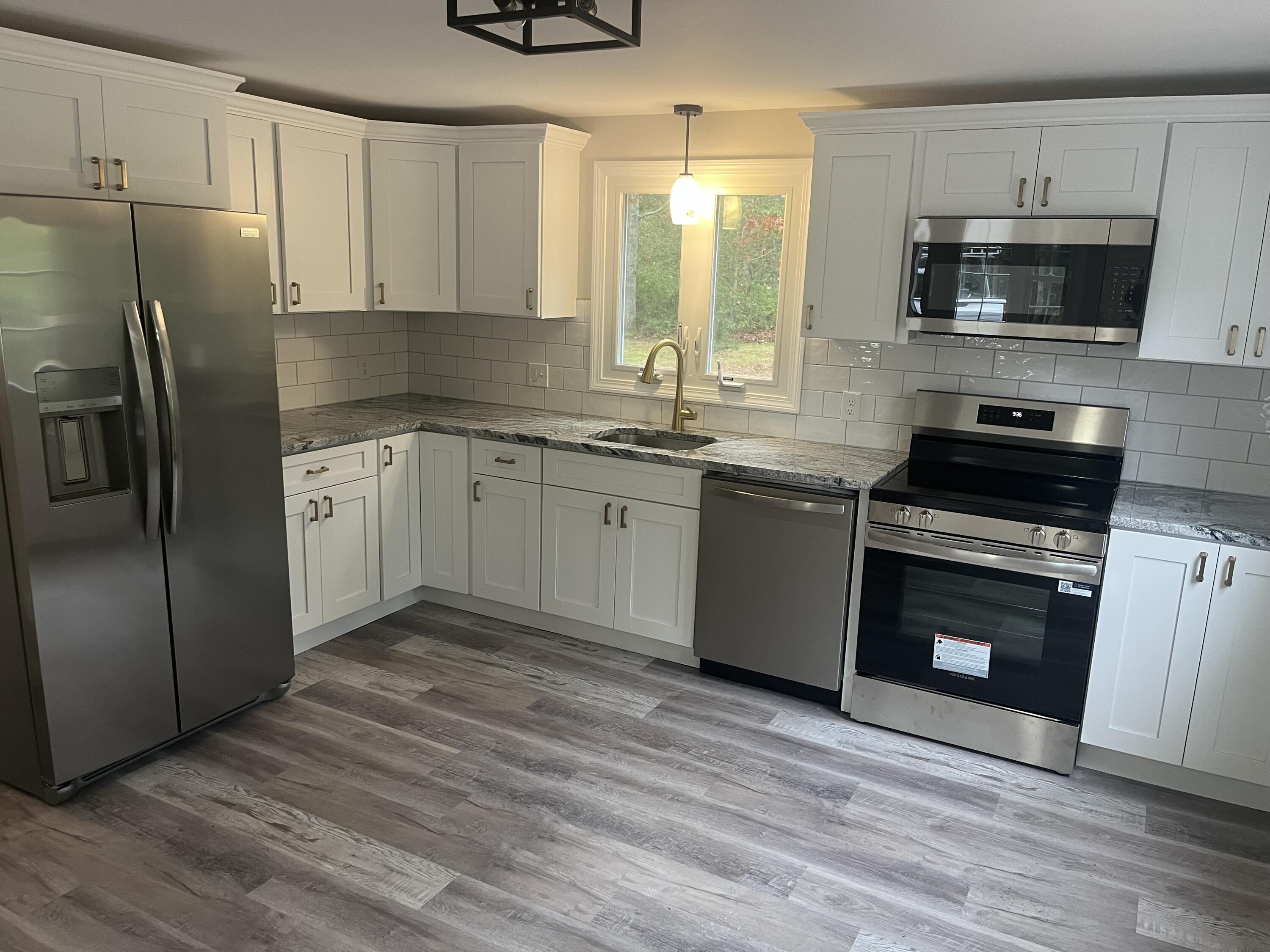 49 Burnham Street Barnstable, MA 02648 - Photo 5 of 17 a kitchen with stainless steel appliances granite countertop a stove a sink and a refrigerator