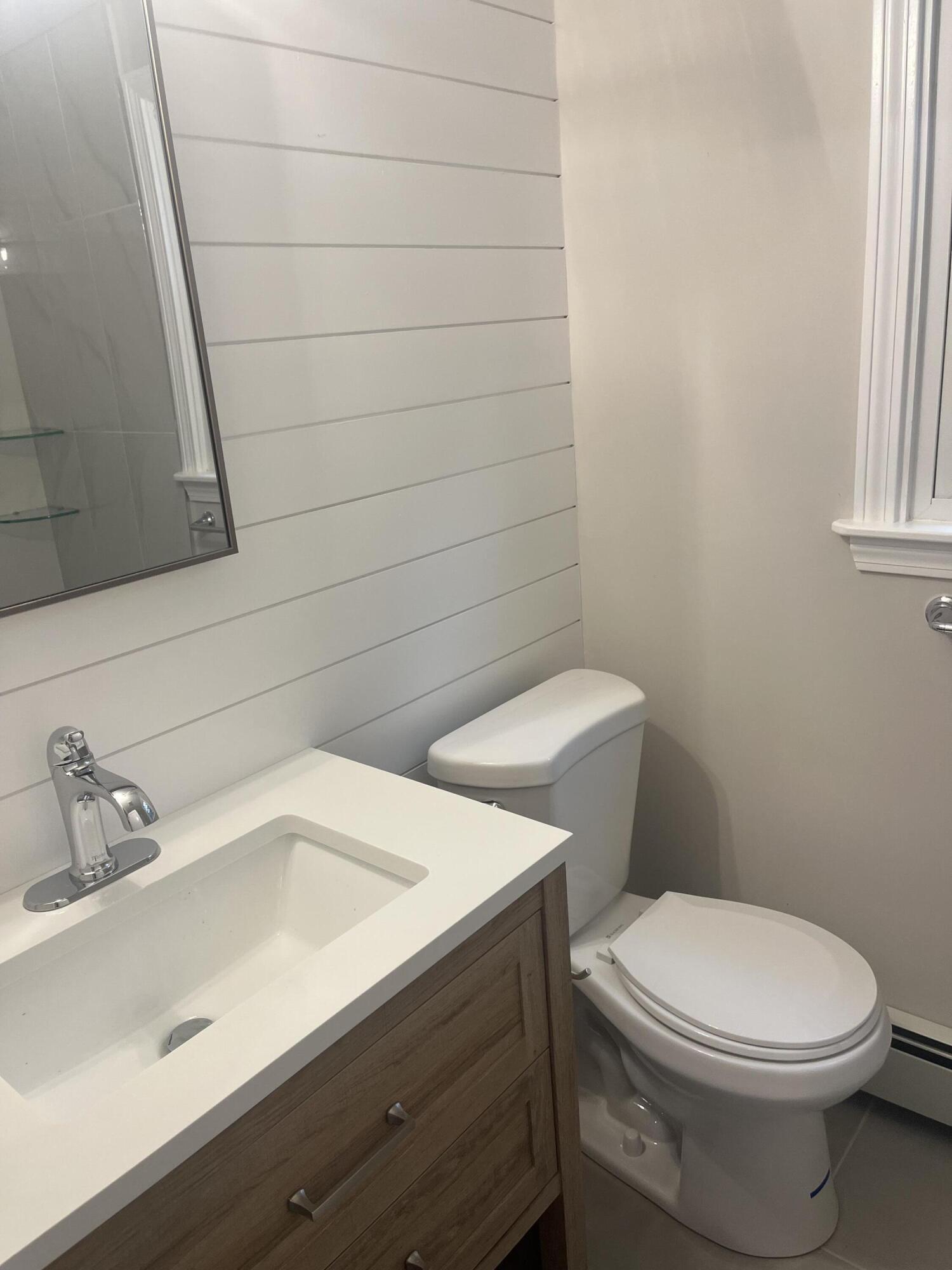 49 Burnham Street Barnstable, MA 02648 - Photo 6 of 17 a white toilet sitting next to a bathroom sink