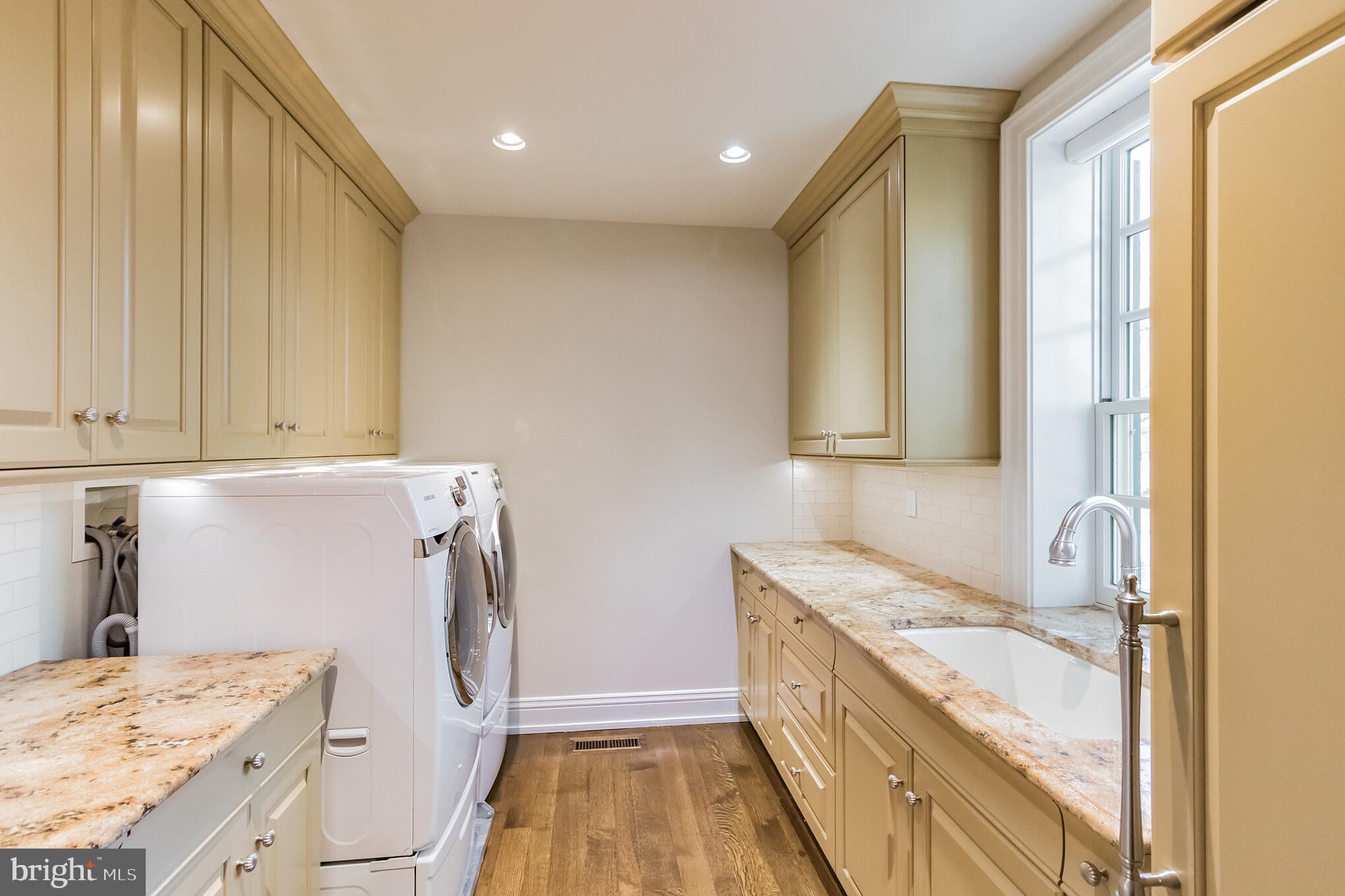 1911 Stone Ridge Lane Villanova, PA 19085 - Photo 17 of 32 a bathroom with a granite countertop sink a washer and dryer
