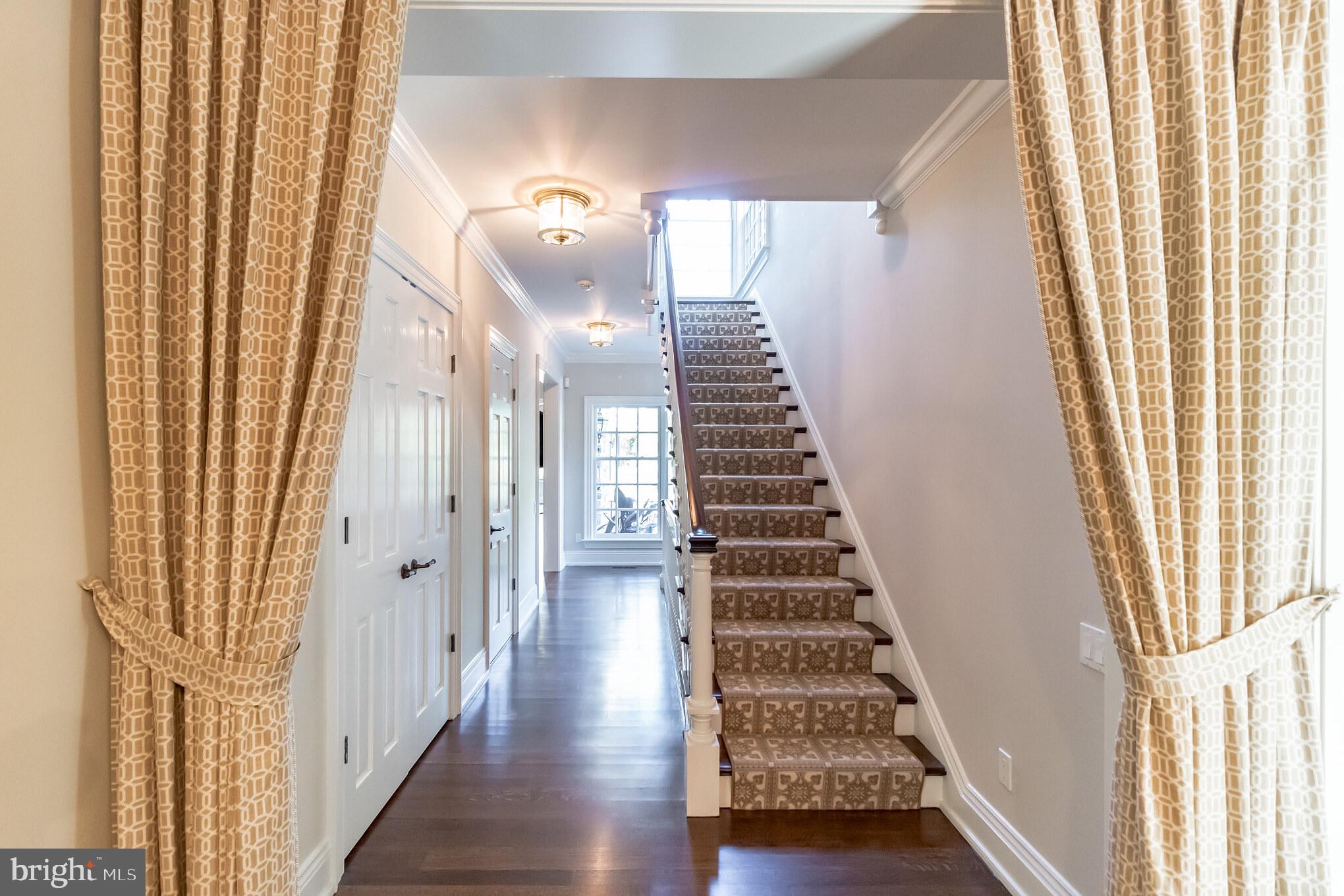 1911 Stone Ridge Lane Villanova, PA 19085 - Photo 7 of 32 a view of a hallway with wooden floor and staircase