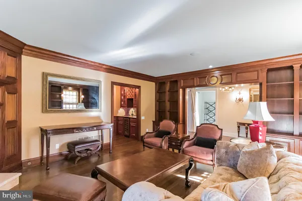 a dining room with furniture a chandelier and wooden floor