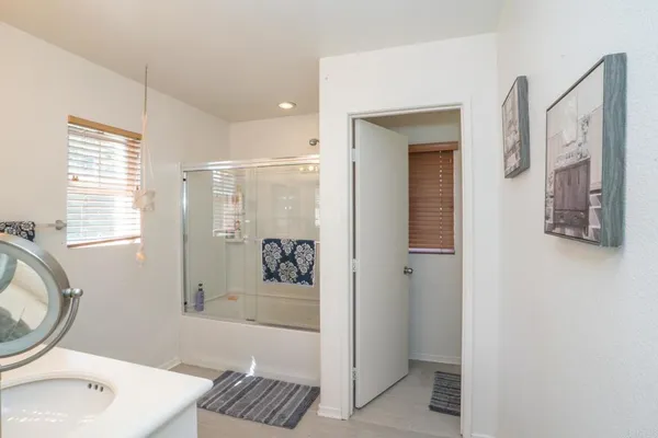 a en suite bathroom with a sink a mirror and a shower