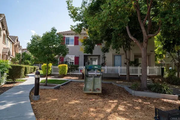 a view of a two chair and tables in the patio