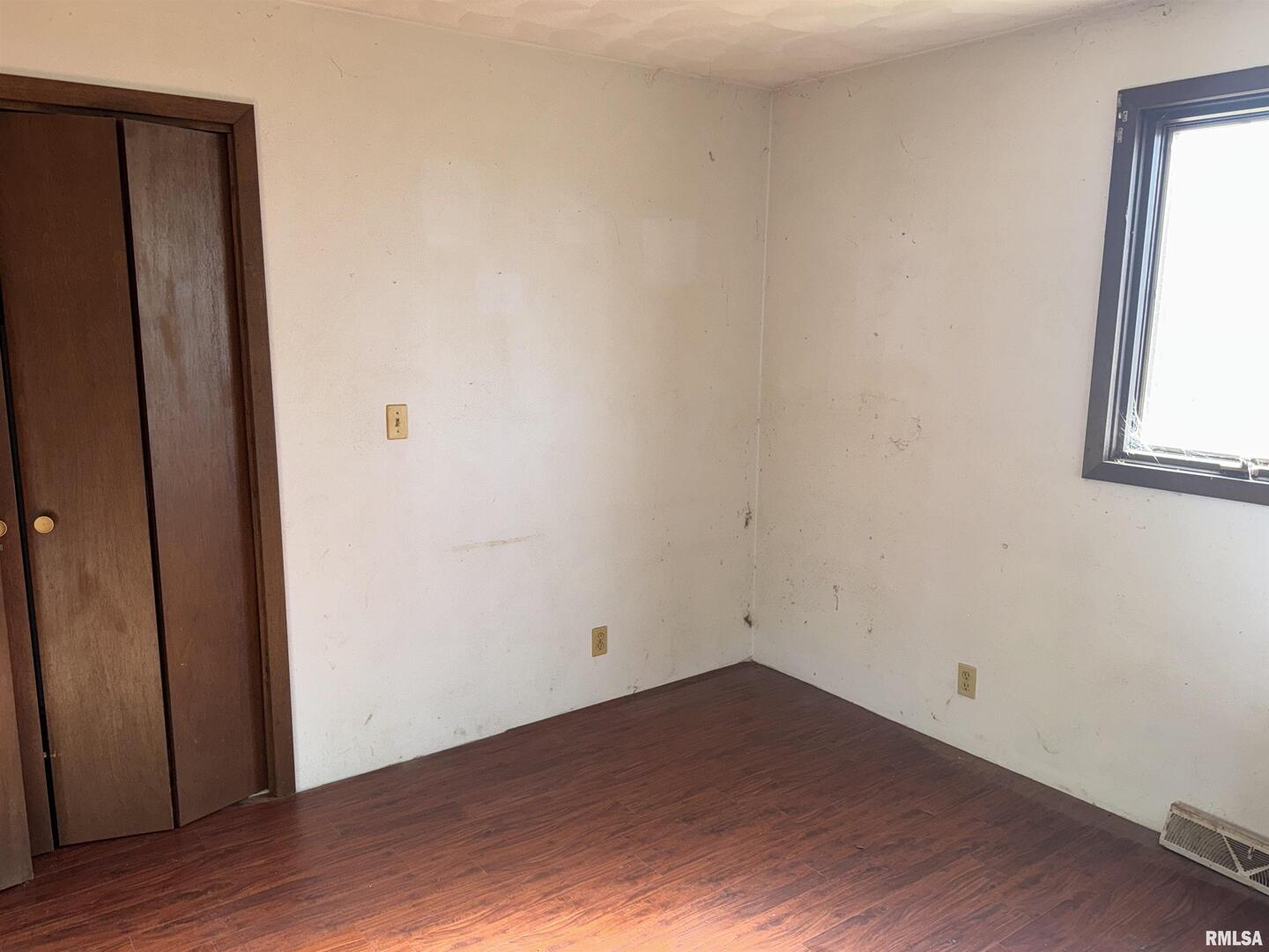 28597 Ropp Road Geneseo, IL 61254 - Photo 11 of 25 an empty room with wooden floor and windows