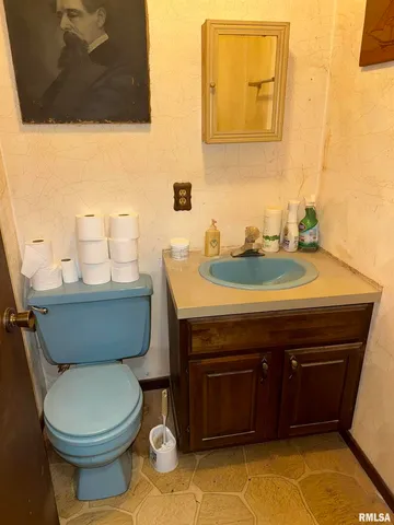 a bathroom with a sink a toilet and mirror