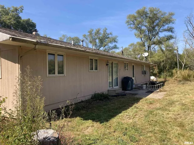 a front view of a house with yard and seating area