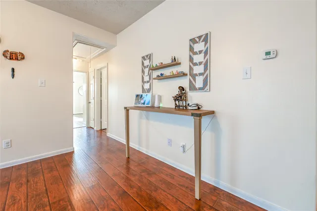 a view of a room with wooden floor and cabinet