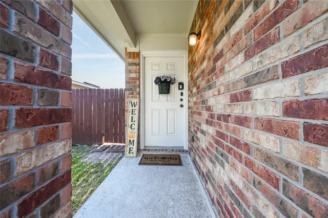 a view of a door and brick wall