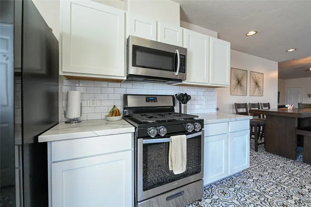 a kitchen with a stove and a microwave
