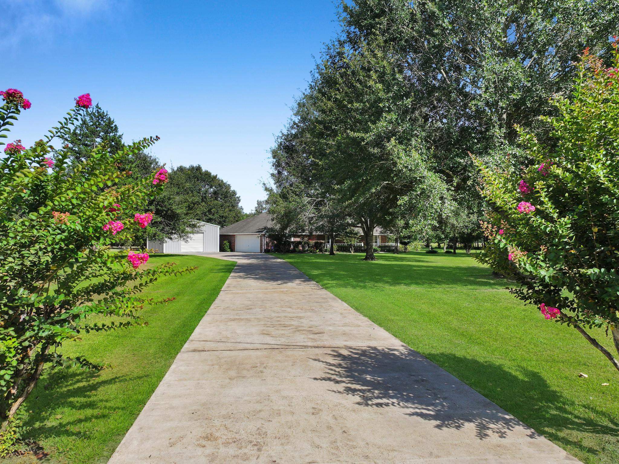 738 Parish Road Orange, TX 77632 - Photo 5 of 45 a front view of a house with a yard and fountain