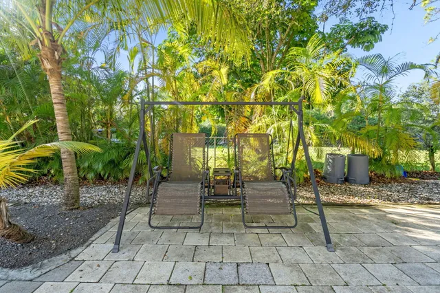 a kitchen with kitchen island granite countertop a sink and a stove