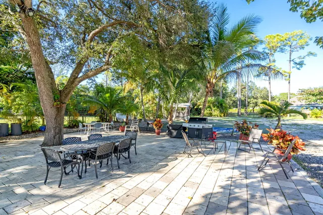 a view of a dining room with furniture and a chandelier