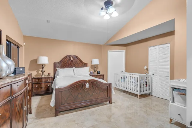 a bed room with a bed and a chandelier