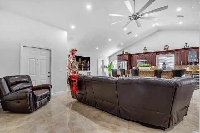 a living room with furniture and kitchen view