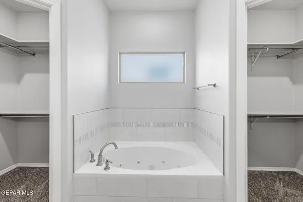 a living room with a flat screen tv furniture and a potted plant