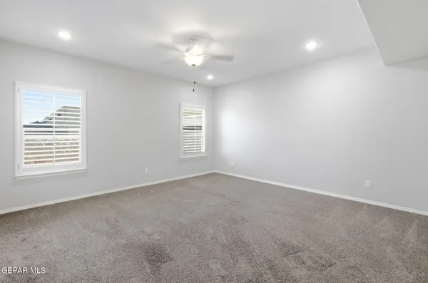 an empty room with a empty space and a ceiling fan