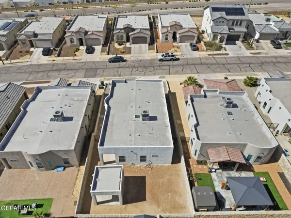 an aerial view of residential houses with outdoor space