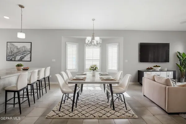 a view of a kitchen with stainless steel appliances granite countertop a refrigerator a oven and a sink