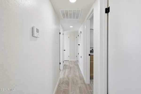 a view of a hallway with a wooden door