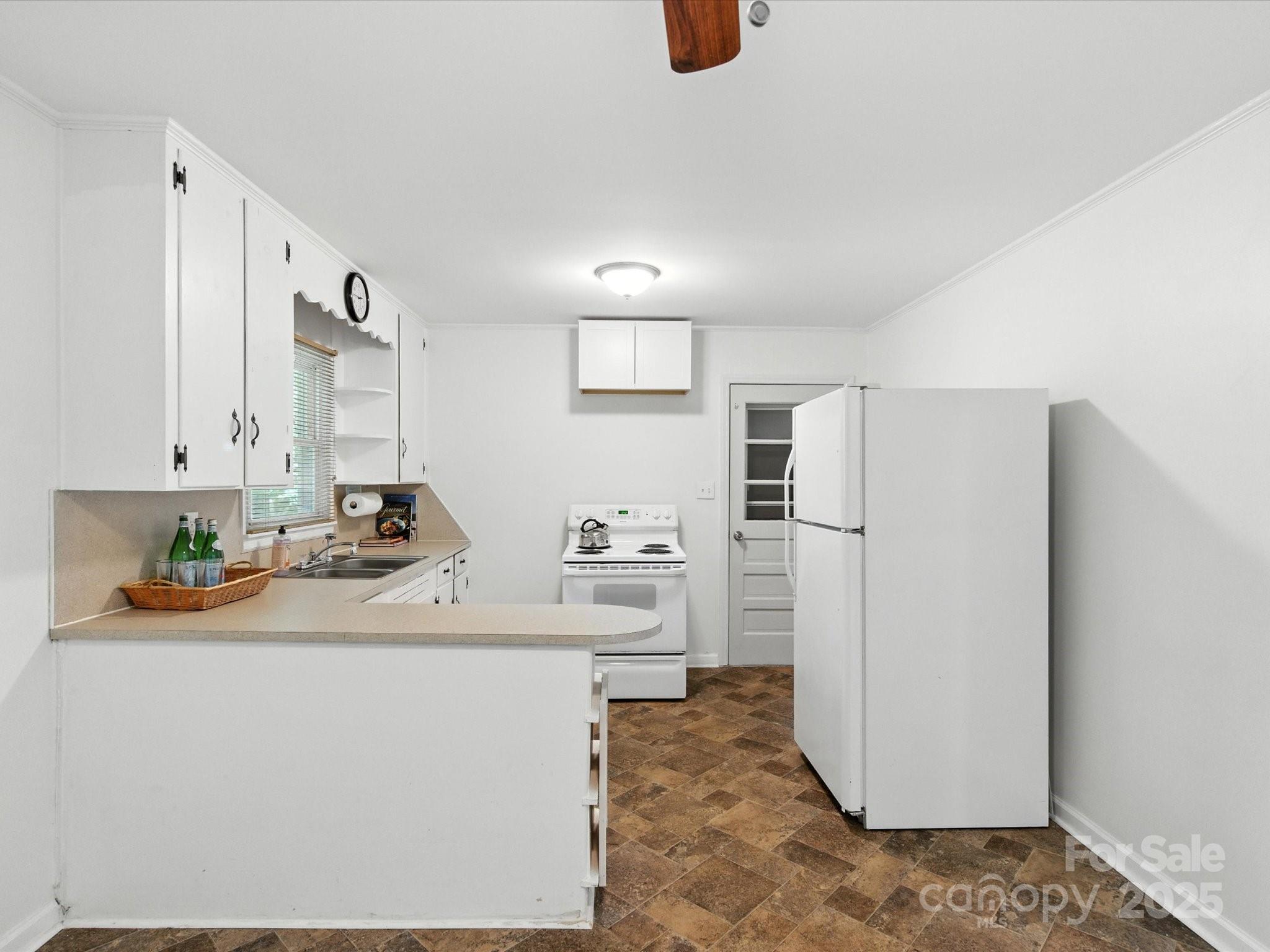 308 Taylor Drive Stanley, NC 28164 - Photo 12 of 26 a kitchen with a refrigerator and a sink