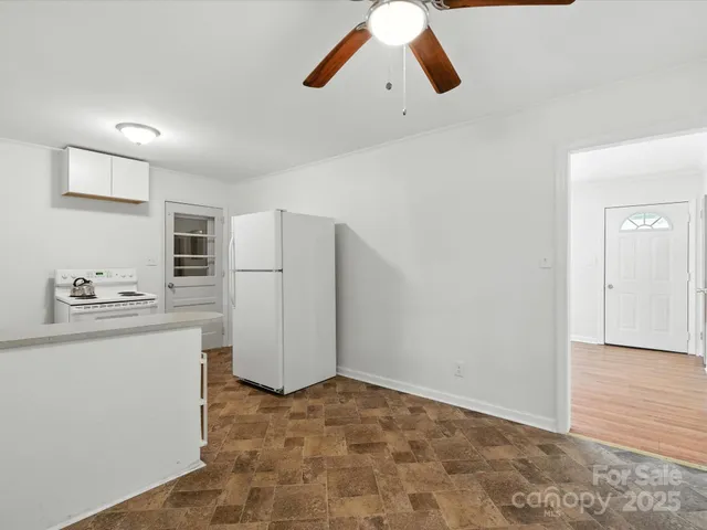a kitchen with refrigerator and cabinets