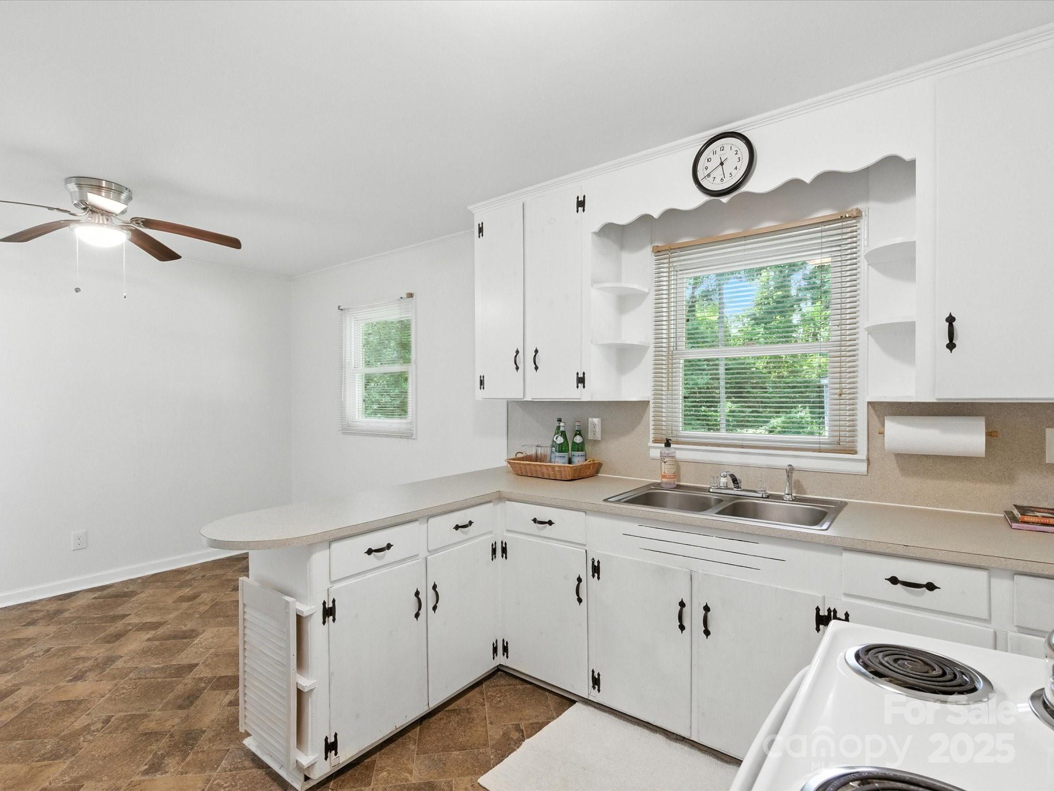 308 Taylor Drive Stanley, NC 28164 - Photo 16 of 26 a kitchen with granite countertop a sink window and cabinets