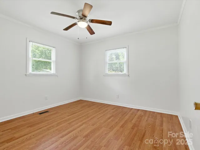 a view of a room with a ceiling fan and a window