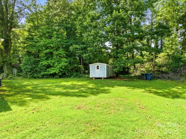 a view of a backyard with a small cabin