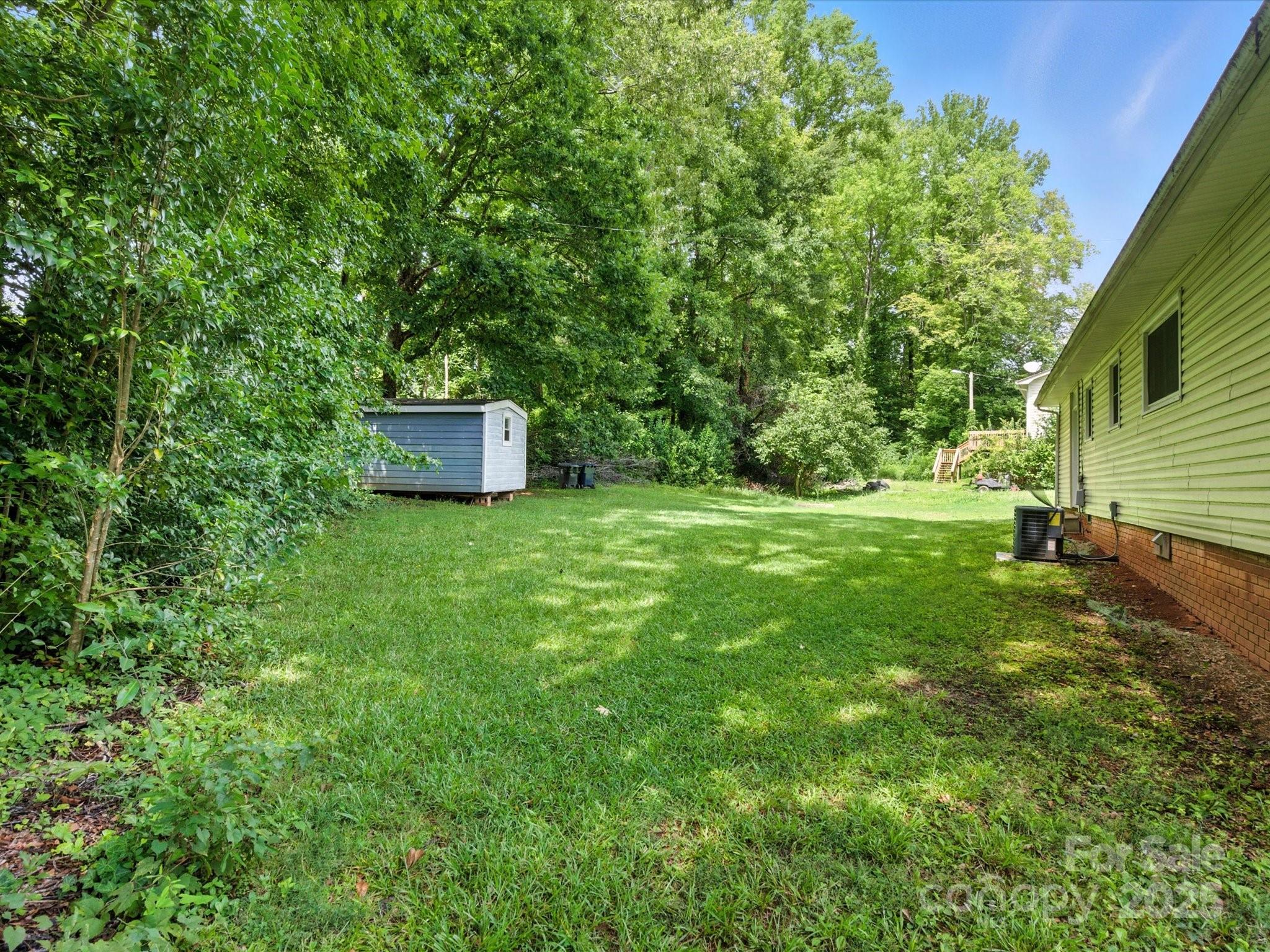 308 Taylor Drive Stanley, NC 28164 - Photo 26 of 26 a view of a backyard with a small cabin