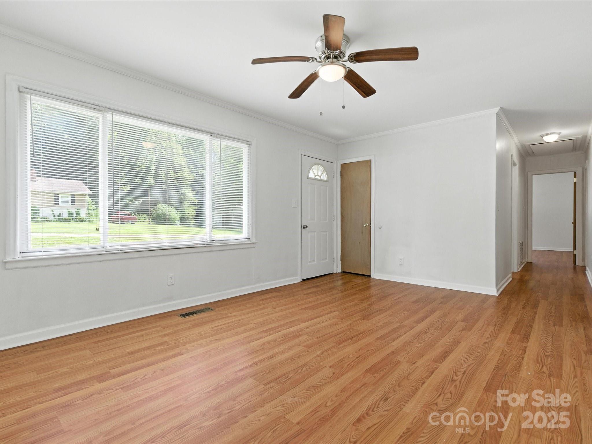 308 Taylor Drive Stanley, NC 28164 - Photo 4 of 26 a view of an empty room with wooden floor and a window