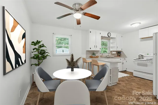 a view of a dining room with furniture and a chandelier