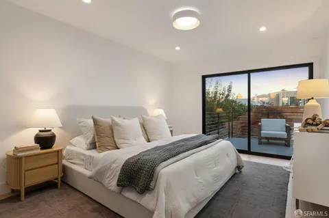 a bedroom with a bed and large window