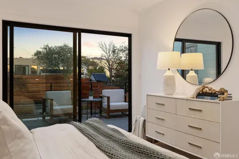 a bedroom with a large bed and a dresser