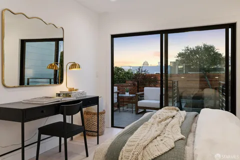 a bedroom with a bed and a large mirror